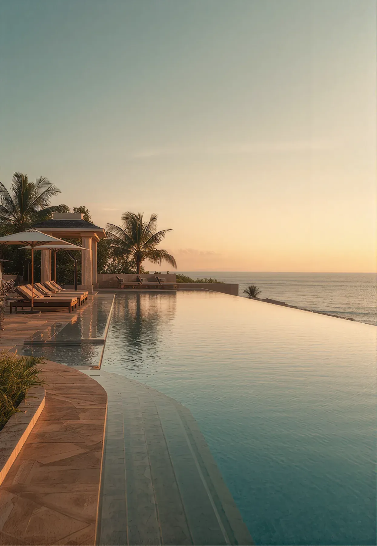 Infinity pool overlooking the valley at dusk with loungers
